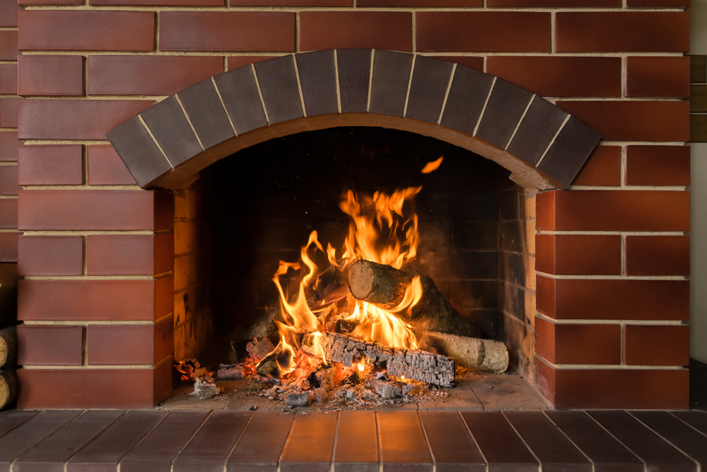 Brick Fireplace with Burning Logs